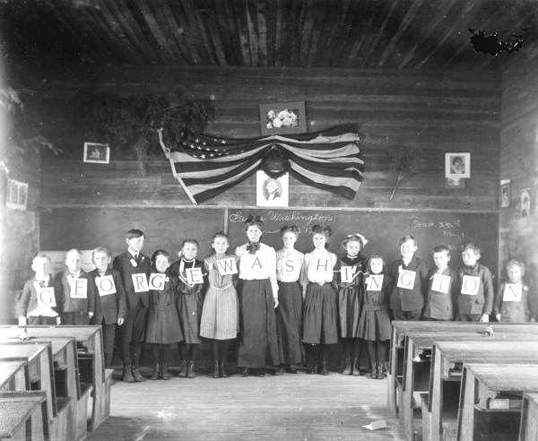 Interior of a Florida one-room school, showing benches and a single chalkboard.