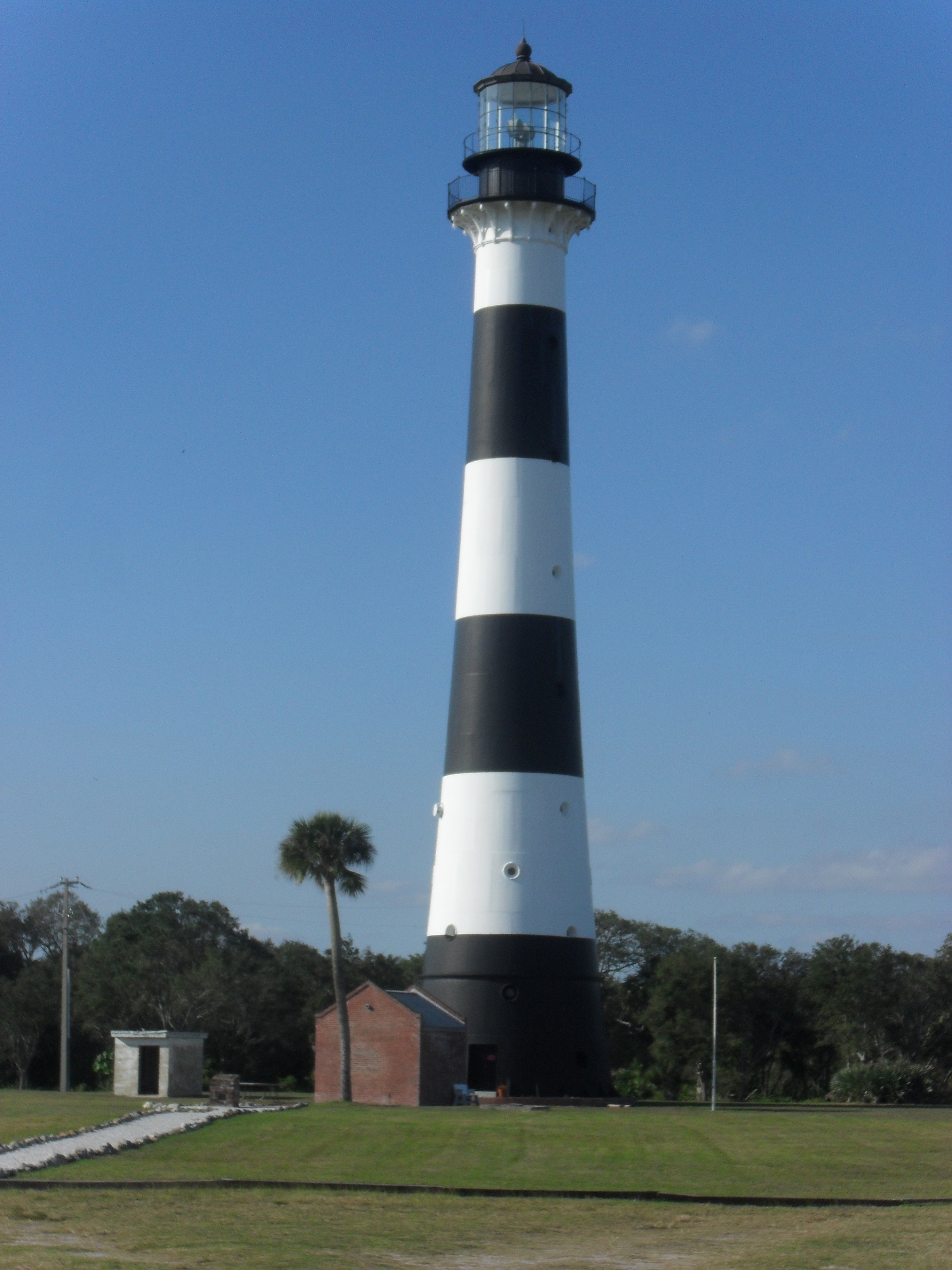 The Cape Canaveral Lighthouse, an iron tower painted in black-and-white bands, on the Cape Canaveral Space Force Station.