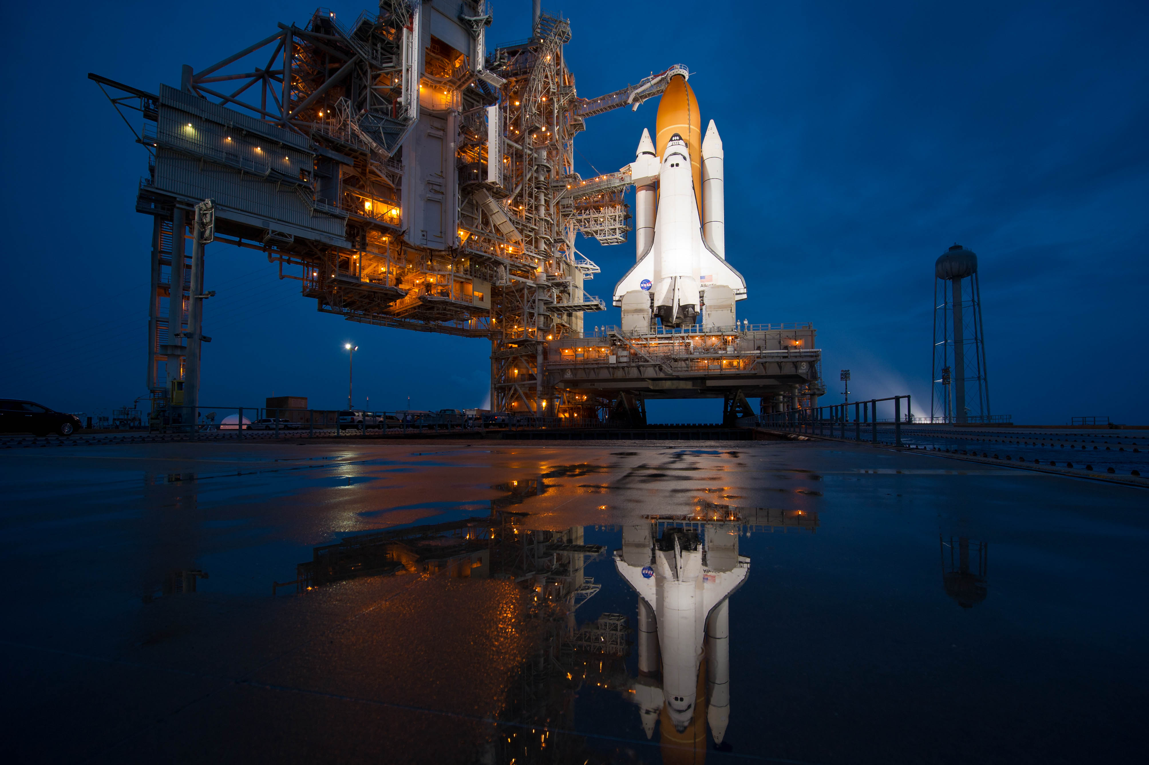 Atlantis on Launch Pad 39A, brightly lit at night for STS-135, the final Shuttle mission.